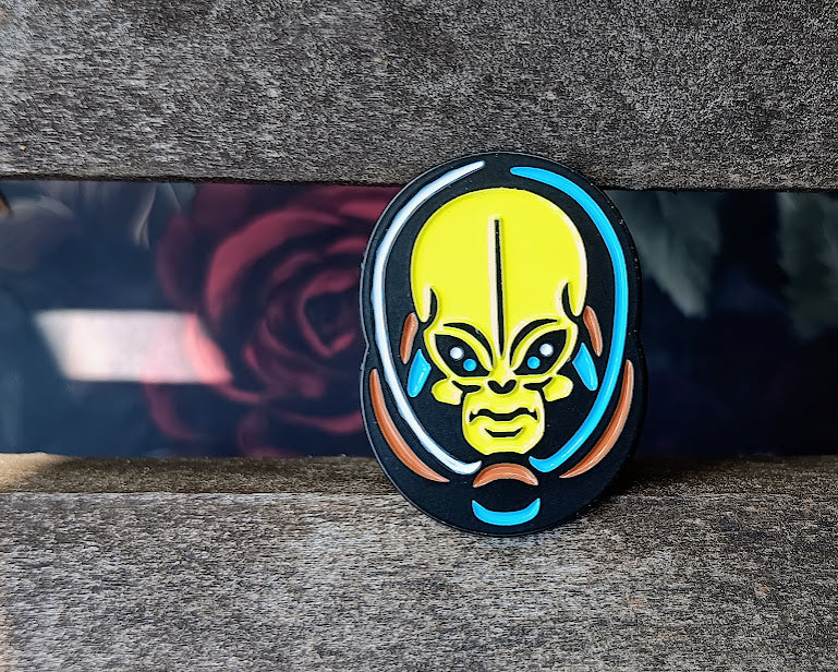 Colorful alien face design on a black background