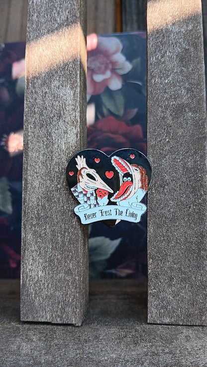 Pin with two dogs in a heart shape on a textured surface